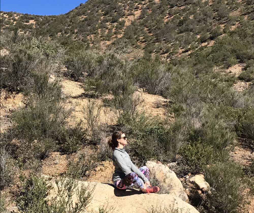 girl meditating on a rock