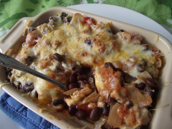 spoon in small casserole dish with bean casserole