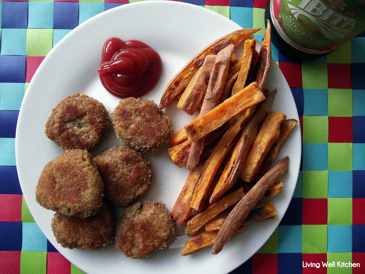 plate of chicken nuggets with ketchup and sweet potato fries
