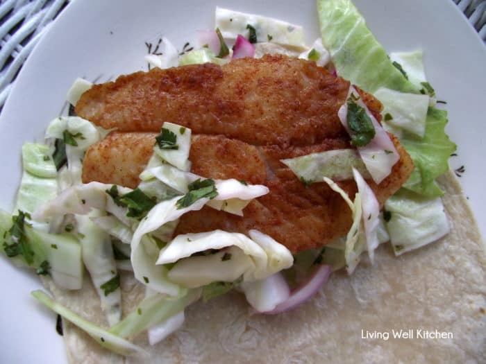 open fish taco on white plate