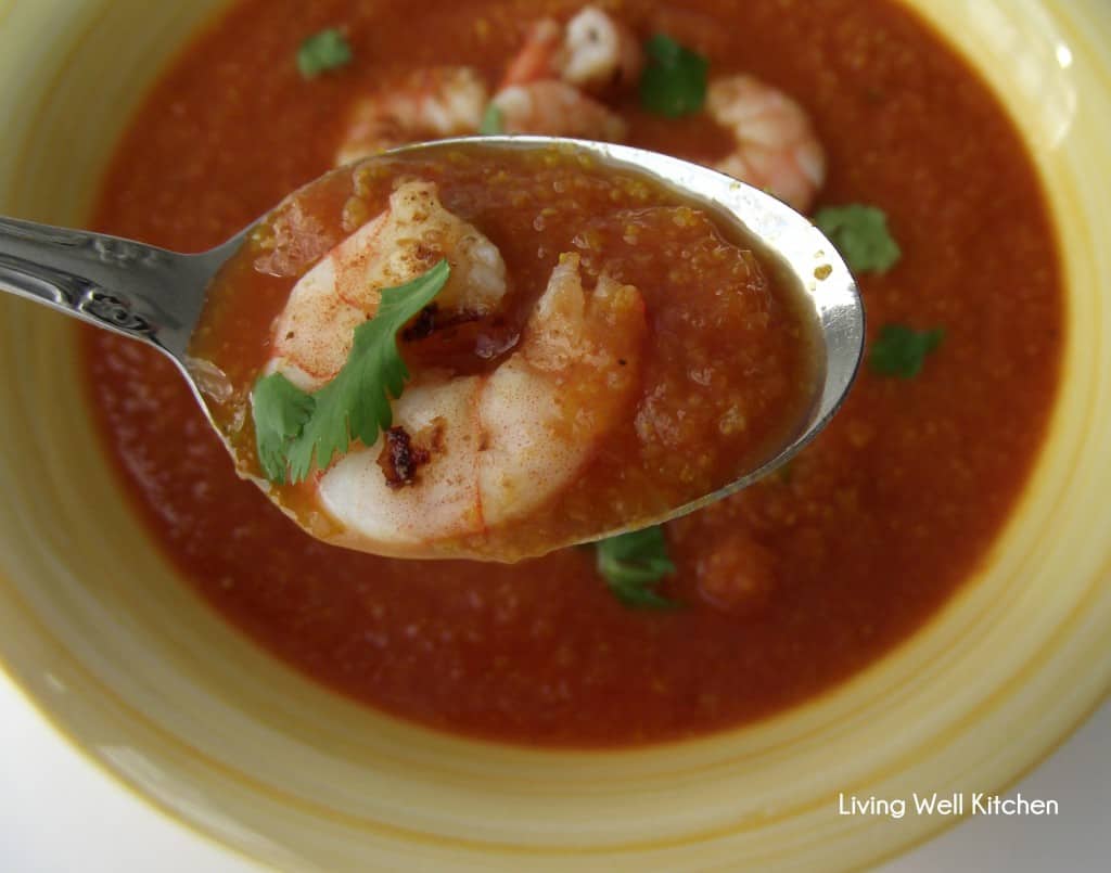bowl of Indian spiced tomato soup topped with shrimp and cilantro
