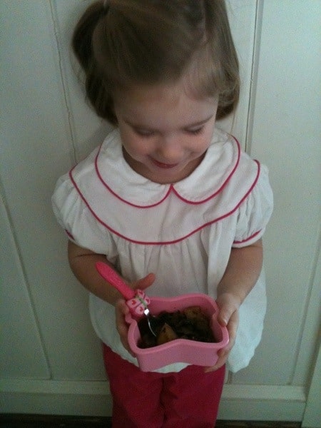 little girl holding a butterfly bowl full of beef stew