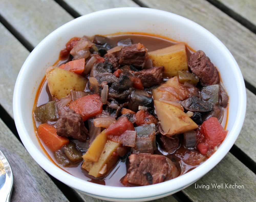 bowl of beef stew on wooden table