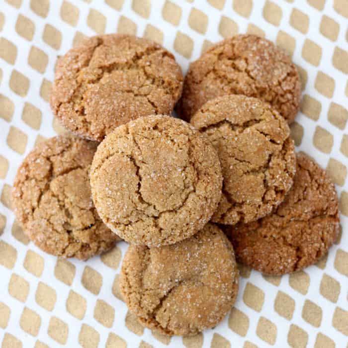 pile of ginger cookies on a gold and white napkin