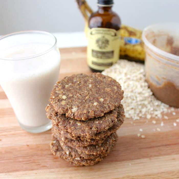 stack of cookies with milk, oats, vanilla, banana, container of almond butter