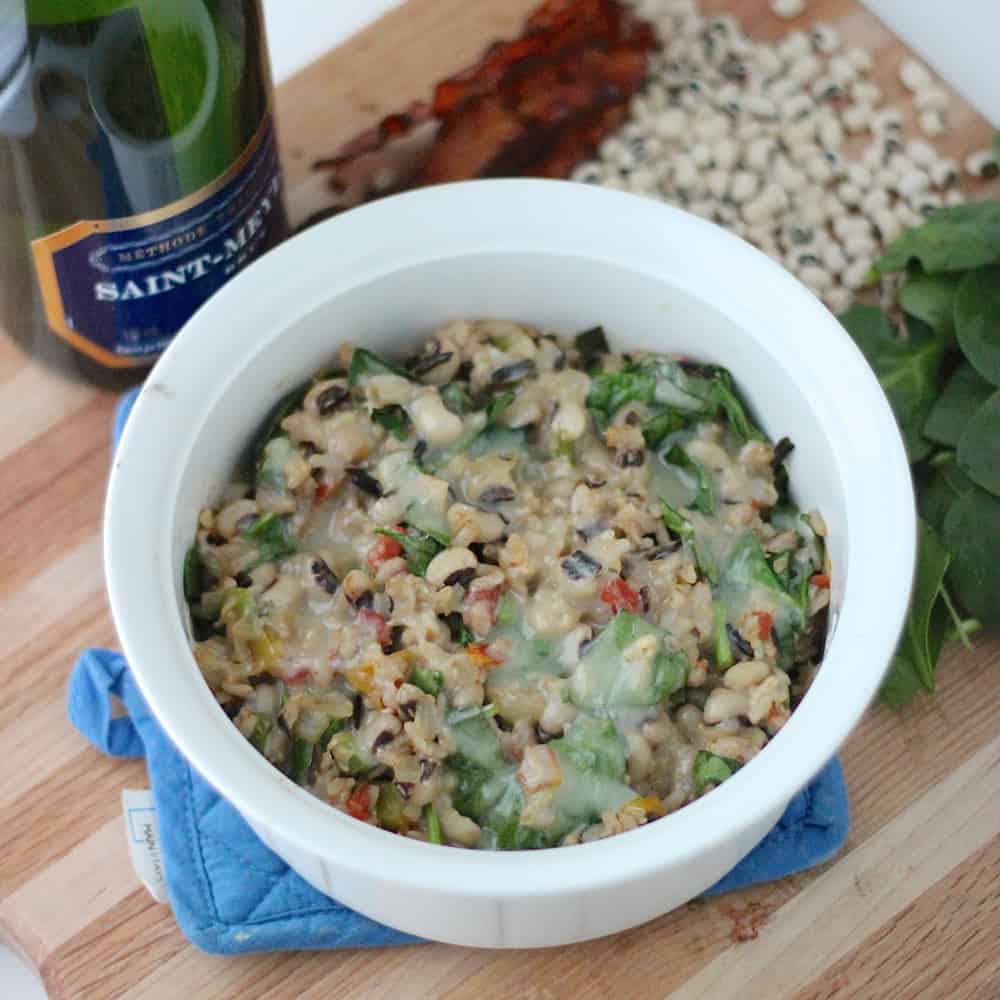 Black Eyed Pea Casserole with champagne, black eyed peas, spinach, and bacon
