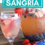pin image with a glass of sangria and a pitcher with blueberries and strawberries