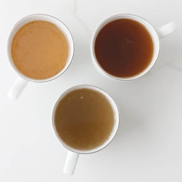 three white cups with different types of bone broth