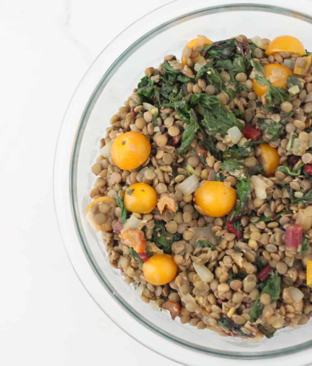 A sweet and spicy dressing complements this giant lentil salad full of late summer veggies ~ Chard and Feta Lentil Salad from Living Well Kitchen @memeinge