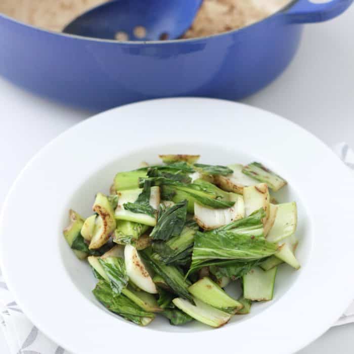white bowl of Five Spice Bok Choy with dutch oven in background