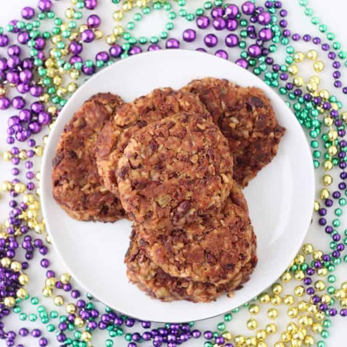 Mardi gras beads with white plate on top with Red Beans and Rice Burgers