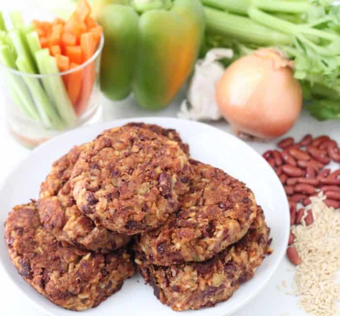 Red Beans and Rice Burger on white plate, rice, red beans, onion, peppers, celery, carrot sticks