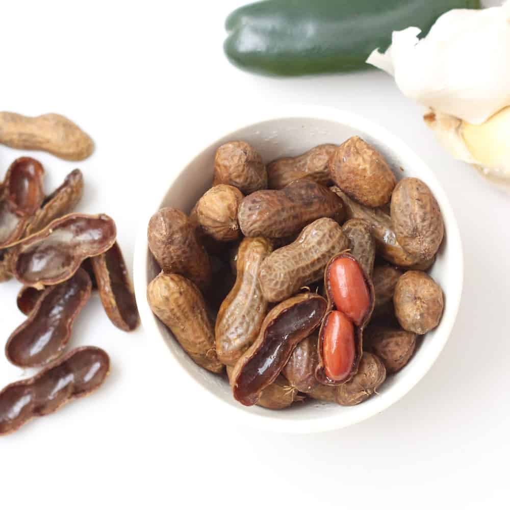 bowl of boiled peanuts with a jalapeno and head of garlic 