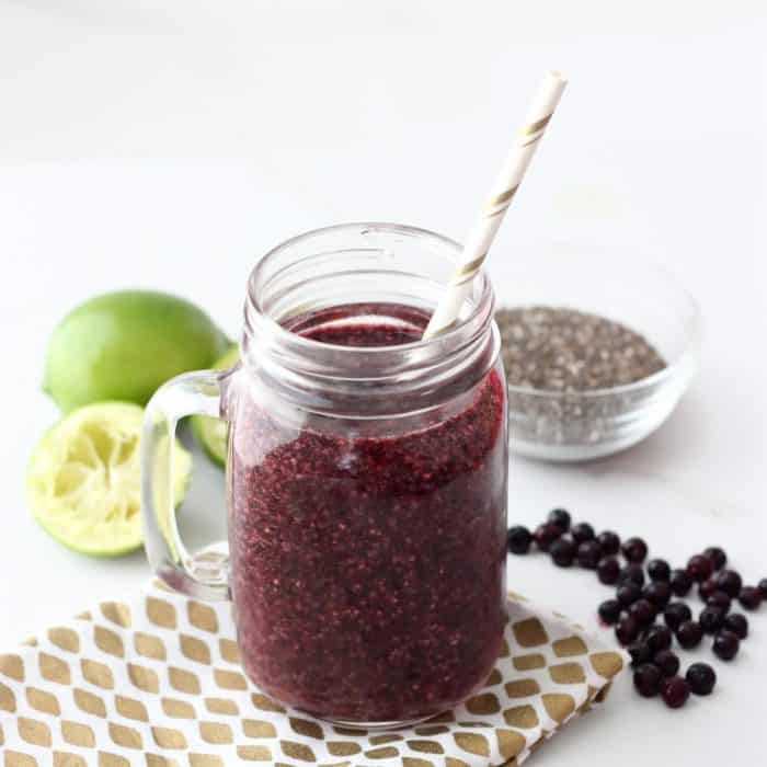 Wild Blueberry Limeade Smoothie in mason jar with straw, frozen wild blueberries, lime, chia seeds