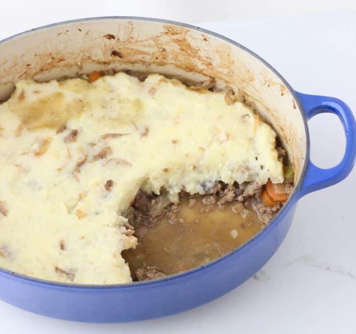 dutch oven with shepherd's pie and some removed