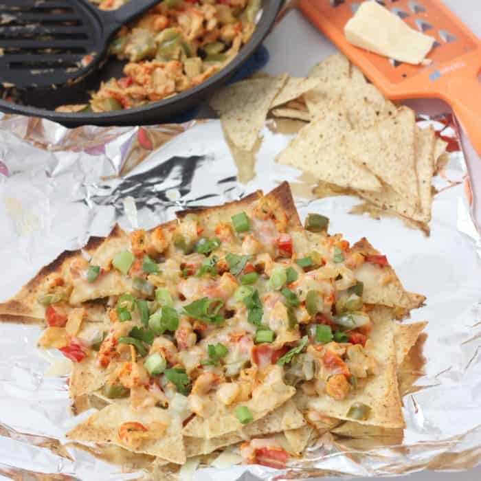 Spicy, cheesy, veggie filled Crawfish Nachos from Living Well Kitchen make for an easy and delicious meal you'll look forward toÂ eating
