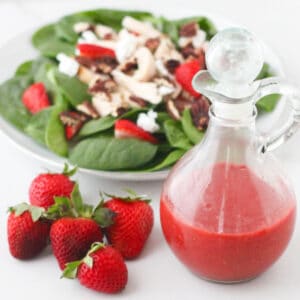 fresh strawberries, bottle of strawberry vinaigrette, spinach salad