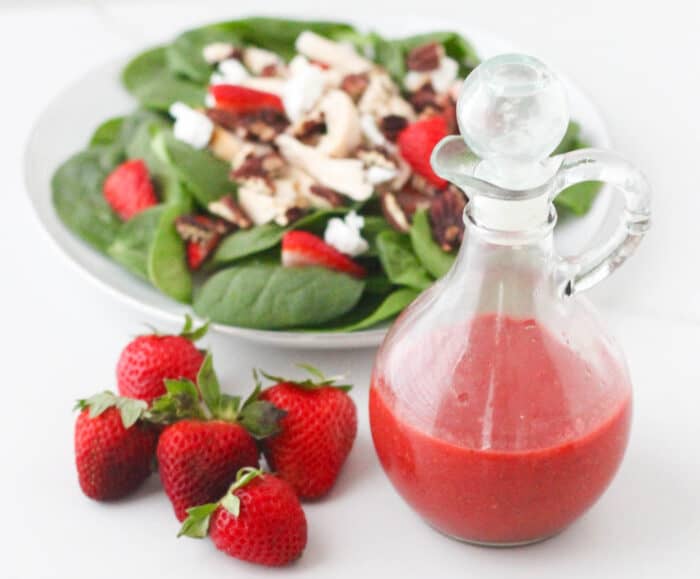 fresh strawberries, bottle of strawberry vinaigrette, spinach salad