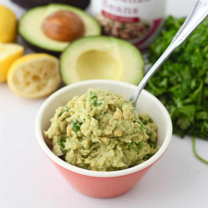 bowl of mashed chickpeas and avocado, fresh cilantro, cut avocado, squeezed lemon, can of chickpeas