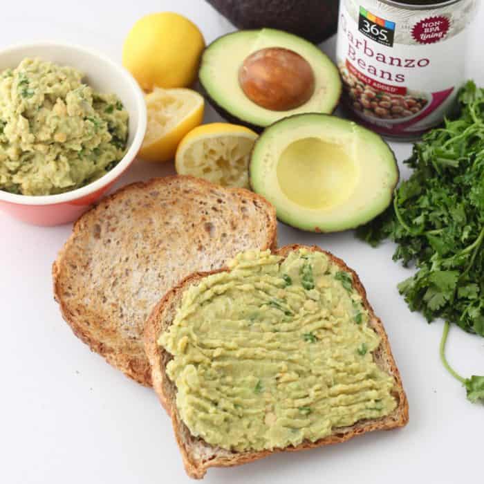 toast with mashed chickpeas and avocado with cut open avocado, can of chickpeas, and cilantro 