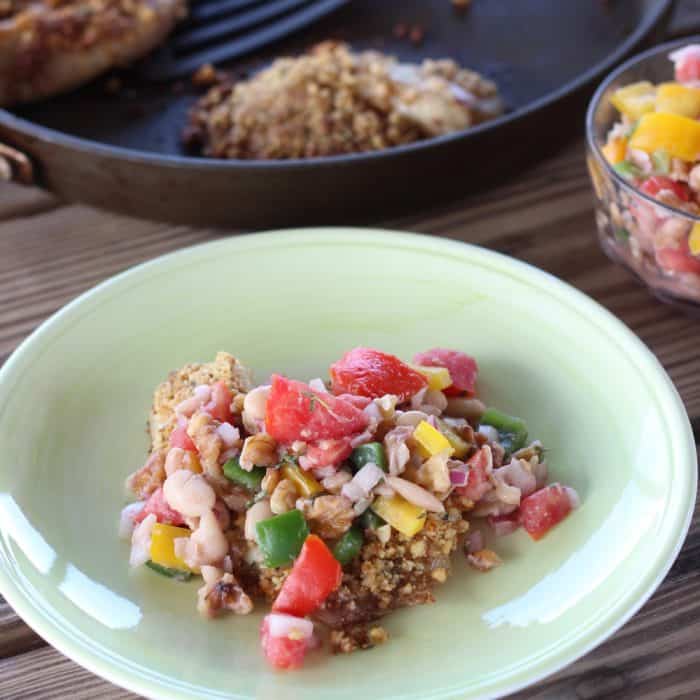 green plate of Walnut Crusted Fish with White Bean and Walnut Salsa, skillet with fish