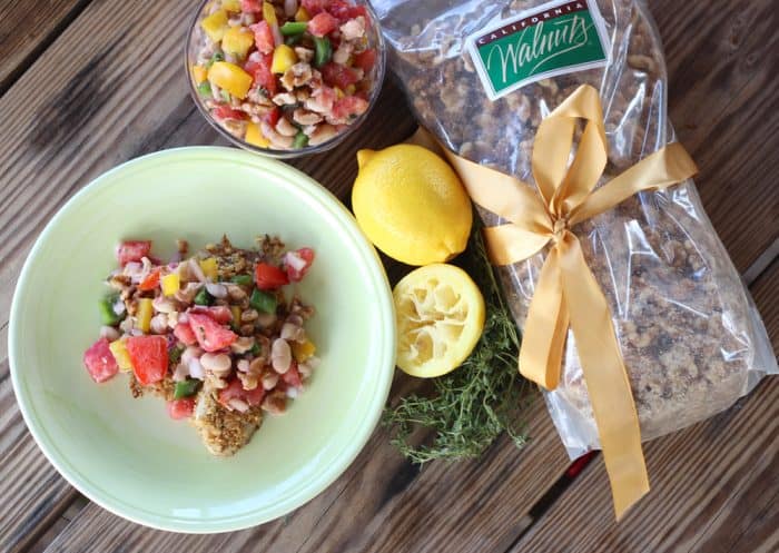 green plate with Walnut Crusted Fish with White Bean and Walnut Salsa, walnuts, lemons, thyme, salsa