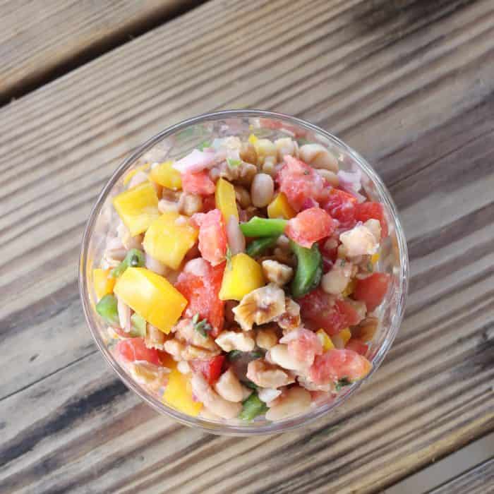 clear bowl with White Bean and Walnut Salsa on wooden table