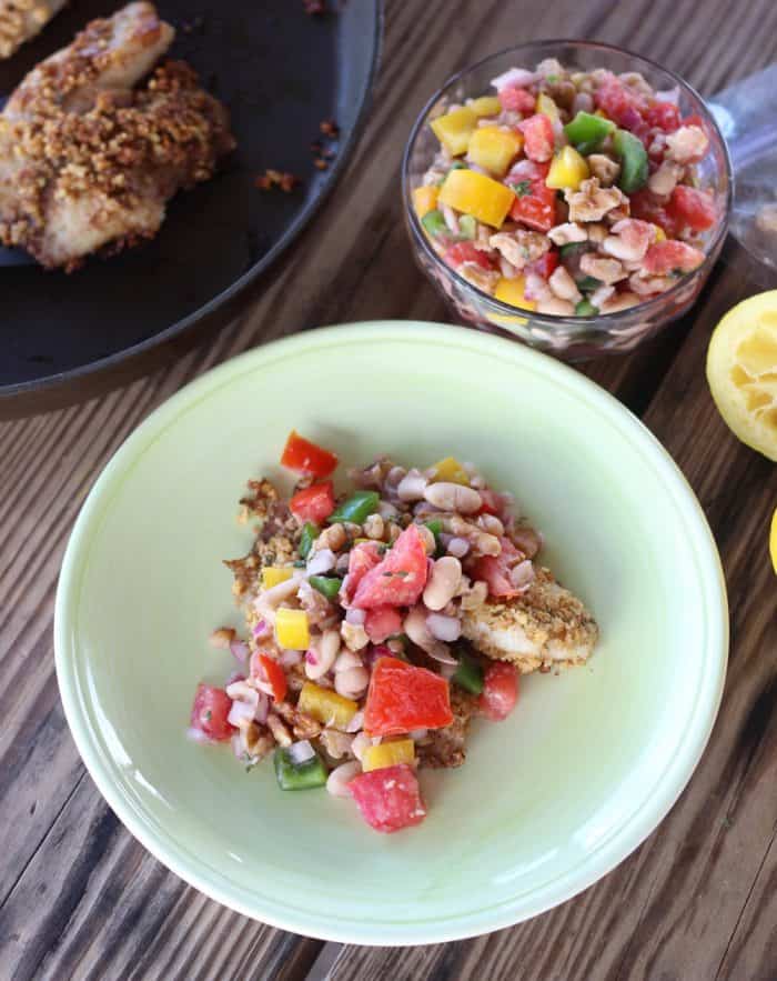 Walnut Crusted Fish in skillet and on plate topped with White Bean and Walnut Salsa and a bowl of salsa 