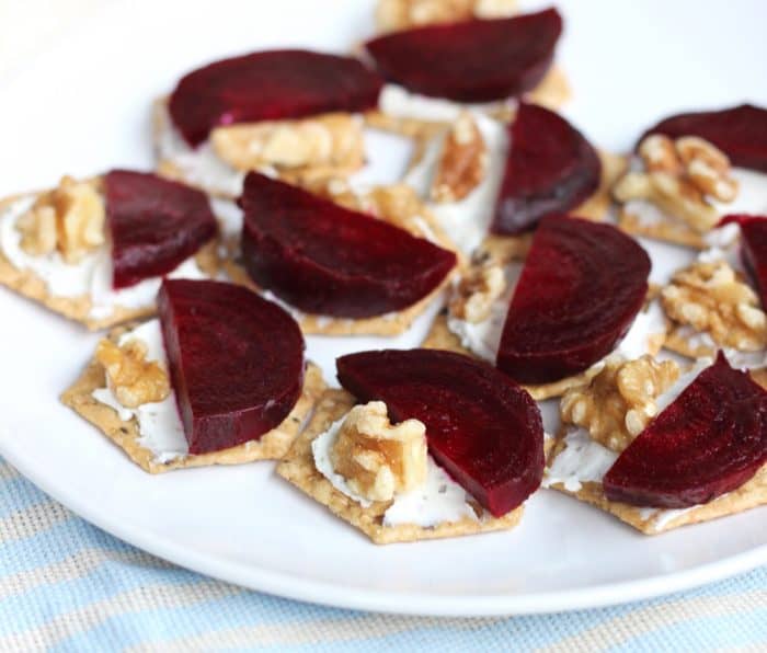 close up plate of Roasted Beet and Goat Cheese Crackers with walnuts