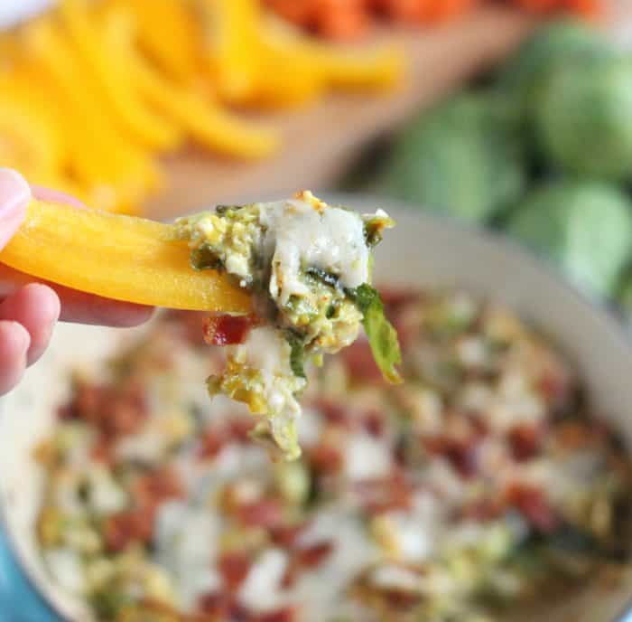 yellow bell pepper holding a Brussel sprout dip