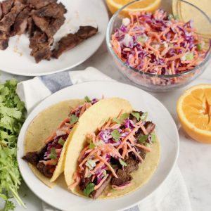 two BBQ Skirt Steak Tacos with slaw and steak