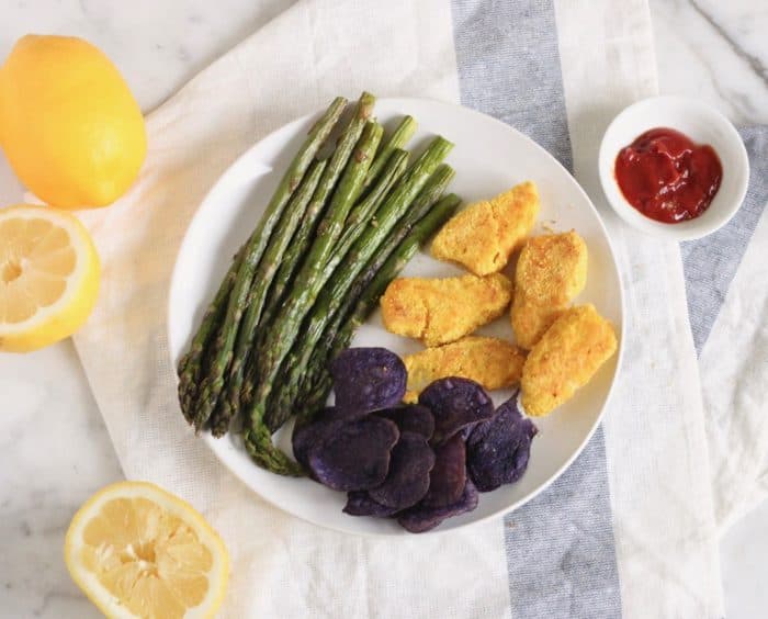 gluten free fish sticks, potato chips, roasted asparagus with lemon and ketchup