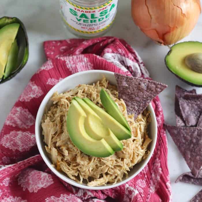 bowl of salsa chicken with tortilla chips and avocado