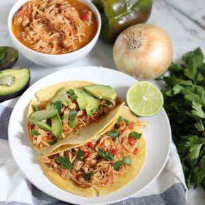 salsa chicken in tortillas with avocados and parsley