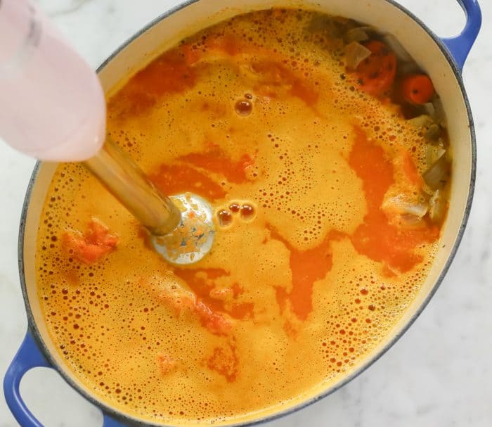 blending carrot soup in a soup pot