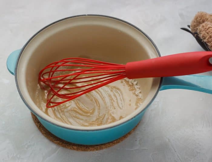 butter and flour being cooked in a saucepan