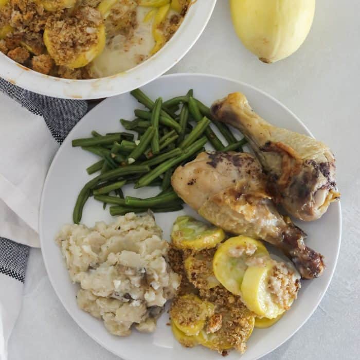 plate of squash casserole, mashed potatoes, green beans, and chicken