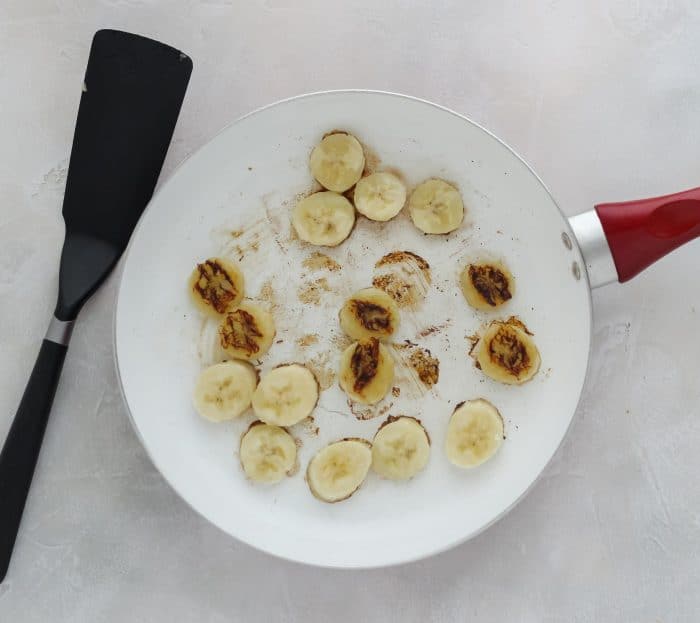 spatula, skillet with cooked bananas