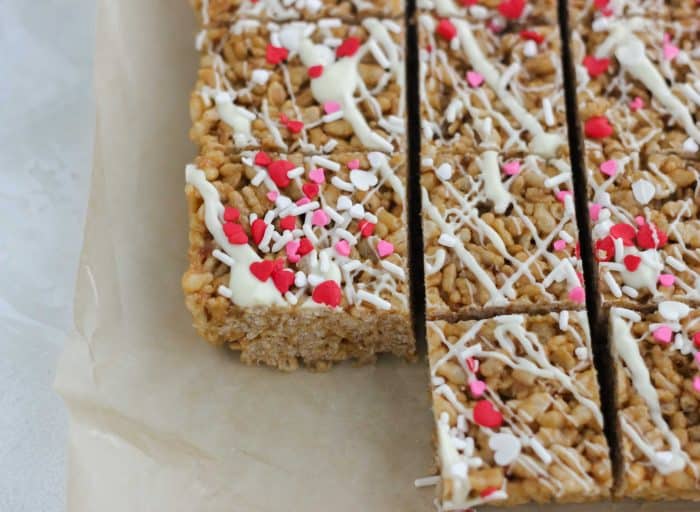 rice crispy treats covered in white chocolate and heart sprinkles