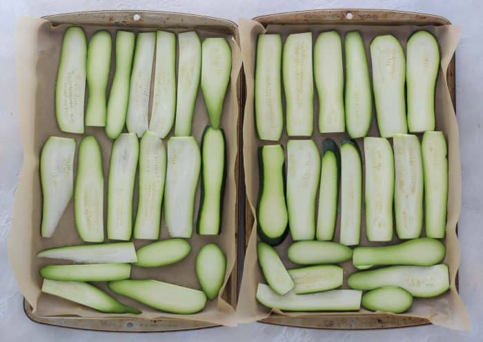 zucchini slices on baking sheets lined with parchment paper