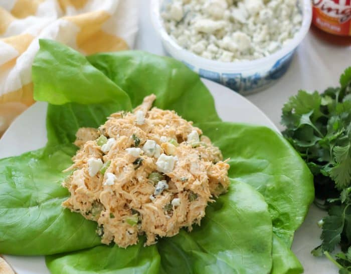 scoop of Buffalo Chicken Salad on lettuce leaves with blue cheese, parsley