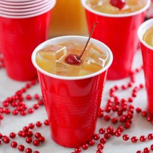 yellow hammer drink in red cup with cherry on top, red beads