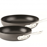 two black skillets with silver handles