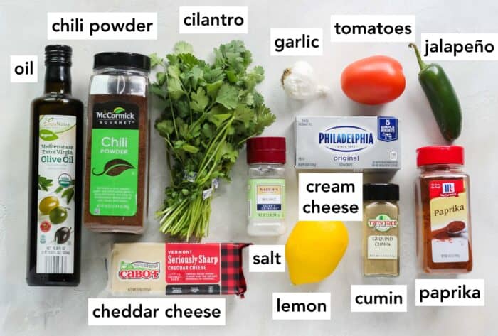 oil, chili powder, cilantro, garlic, salt, tomato, jalapeno, paprika, cumin, lemon, cheddar cheese