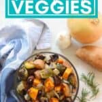 bowl of roasted vegetables on a blue napkin with onion, sweet potato, rosemary, and garlic with "Thanksgiving Veggies" text overlay