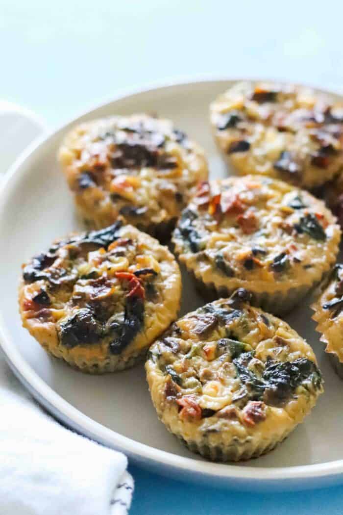 close up photo of a plate of egg muffins on a blue table