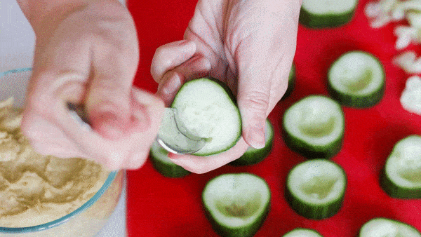 gif of scooping seeds out of cucumber slice