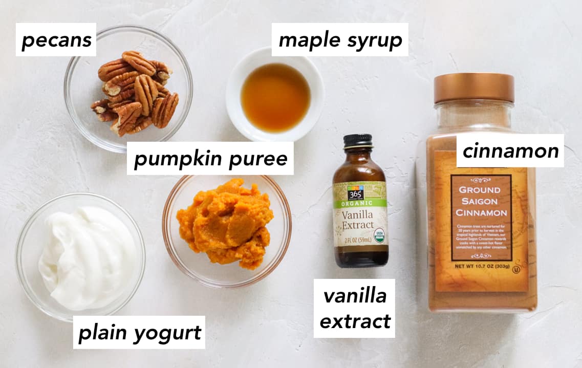 bowl of pecans, bowl of plain yogurt, bowl of pumpkin puree, bowl of maple syrup, bottle of vanilla extract, container of ground cinnamon