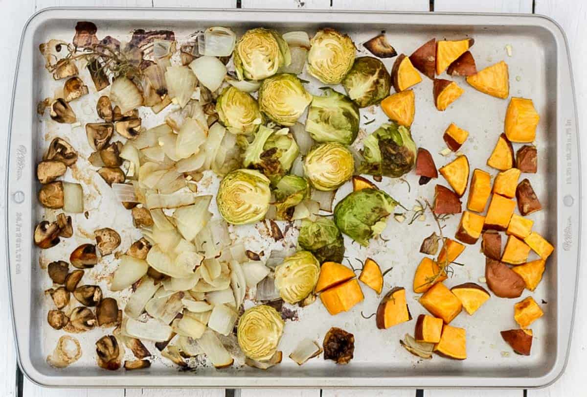 baking sheet with roasted mushrooms, onions, Brussels sprouts, and sweet potatoes