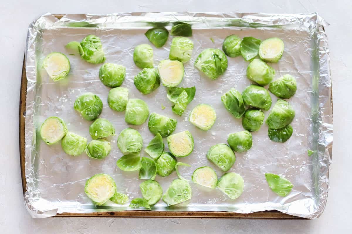 cut Brussels sprouts on a baking sheet tossed with oil and salt